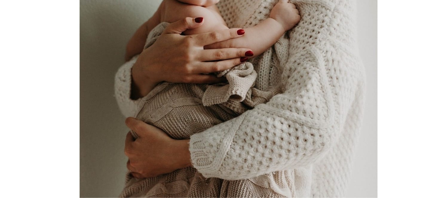 Mother and child hugging at home during separation abroad, showing emotional safety and nervous system regulation